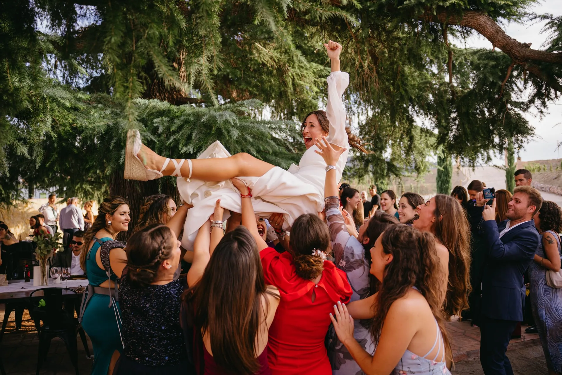 Los invitados mantean a la novia durante la fiesta